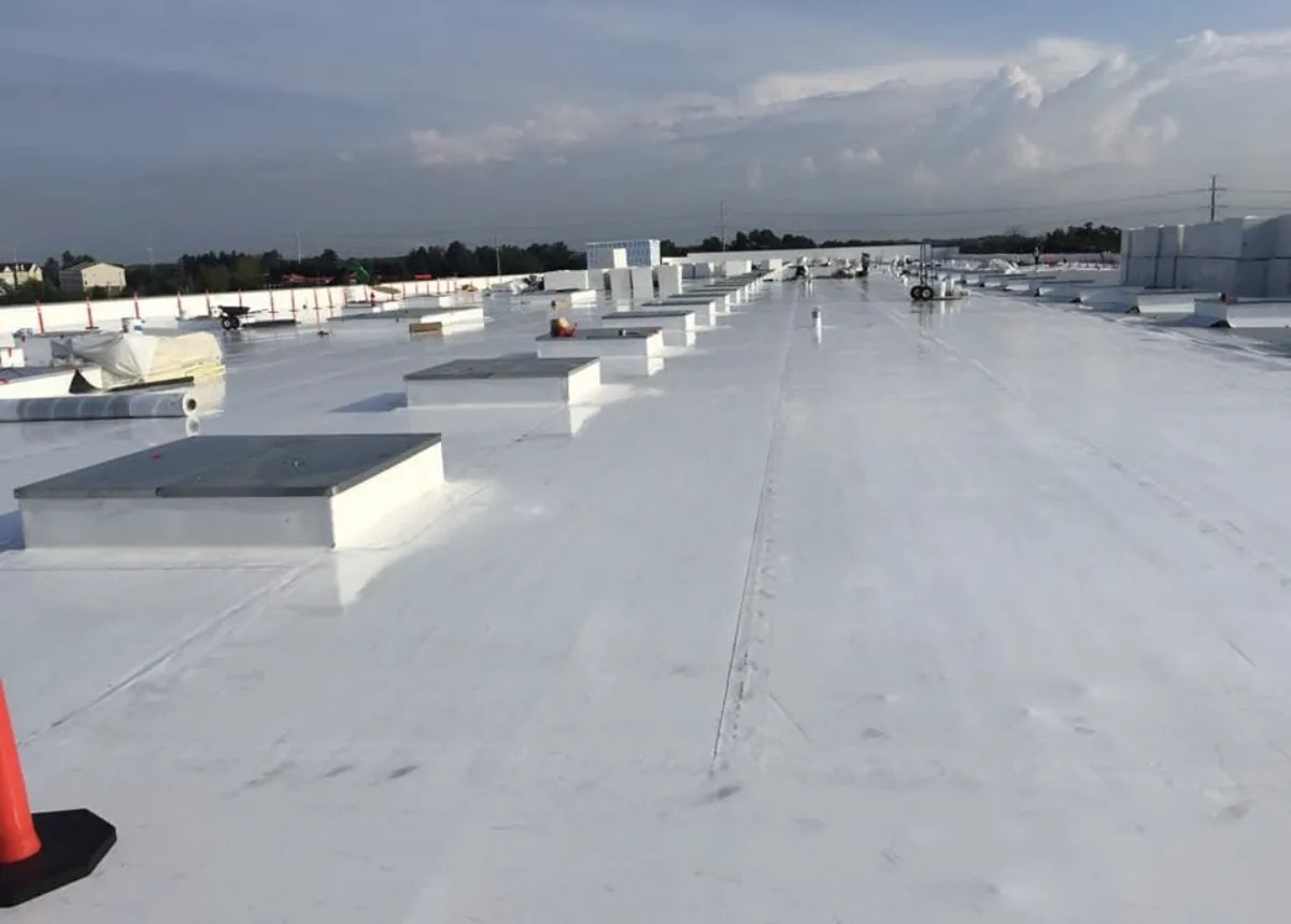 Finished white single-ply commercial roof with curbs and rooftop units installed by Nelson Roof Contracting